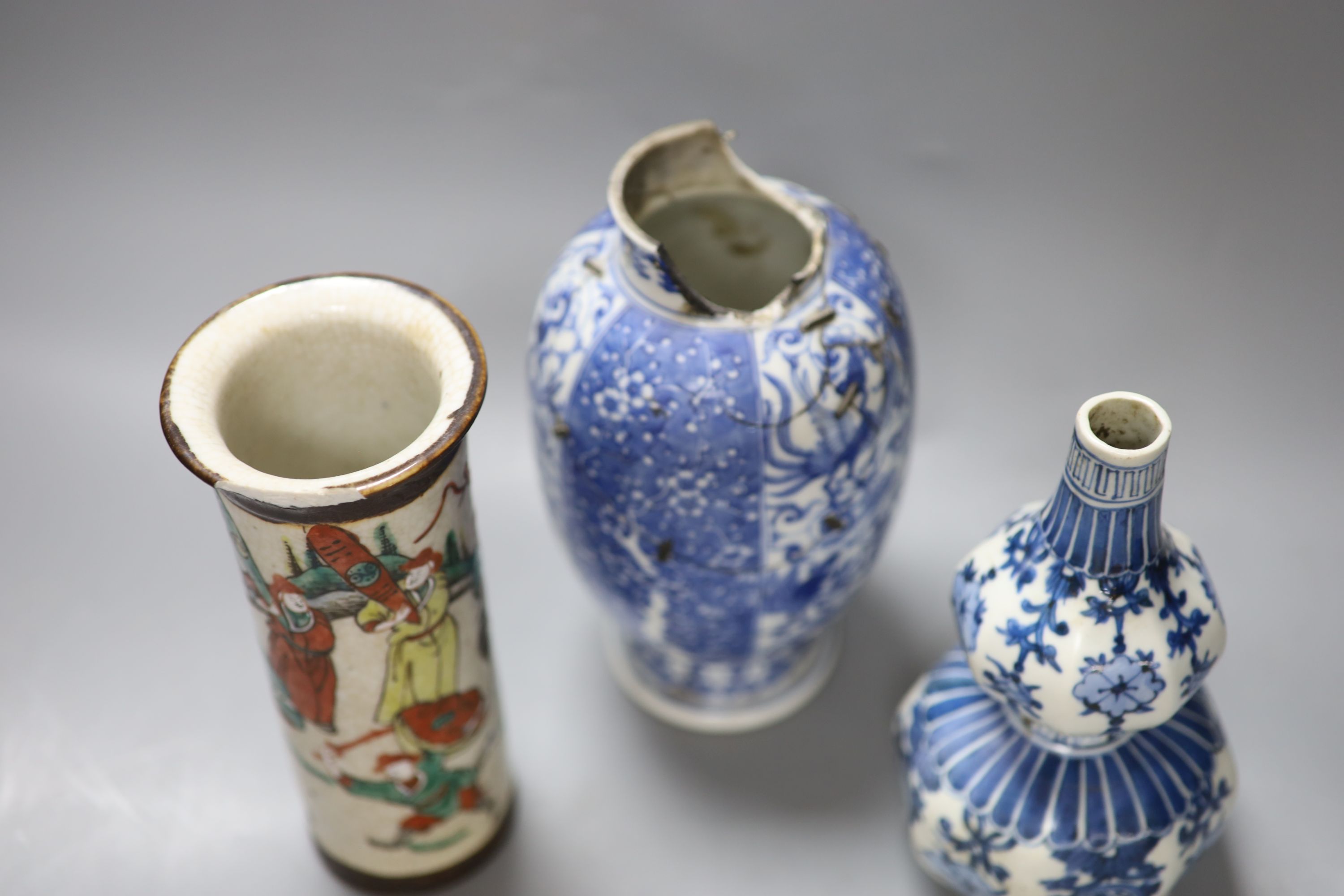 A Chinese blue and white gourd vase, a famille rose sleeve vase and a Japanese blue and white vase, height 20cm (a.f)